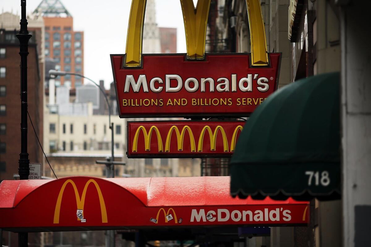 McDonald's Corp. said sales in January fell a worse-than-expected 1.8%. Above, a McDonald's sign hangs in lower Manhattan in New York City.