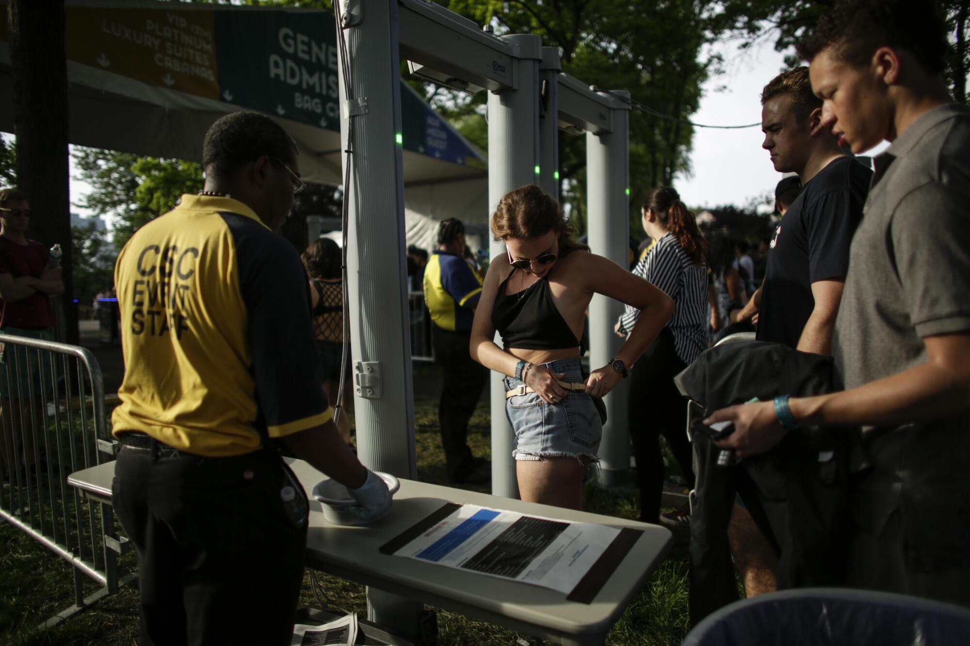 A woman is checked by security staff as she arrives to a concert in New York City on June 2, 2018. 