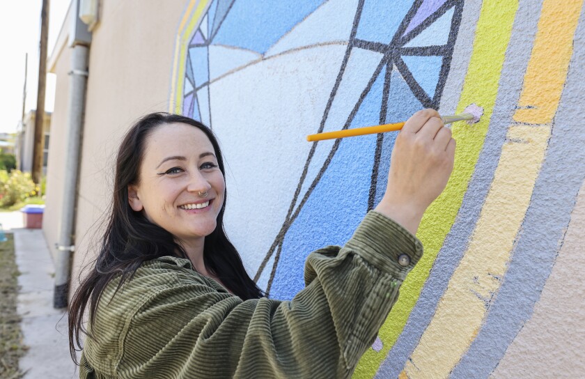 Art teacher Jess Rogawski works on a mural