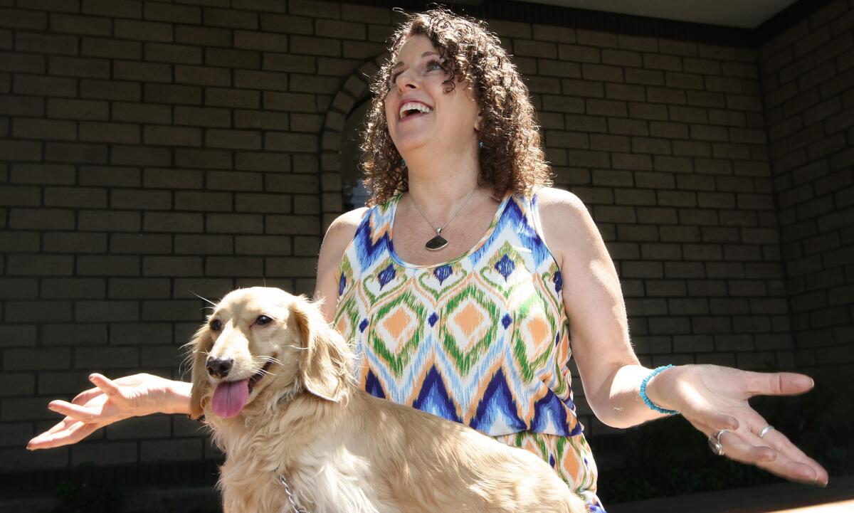 Psychic medium Cate Coffelt talks about her ability to communicate with the deceased as well as animals, with her dog Bailey in her lap, on Monday, July 13, 2015.