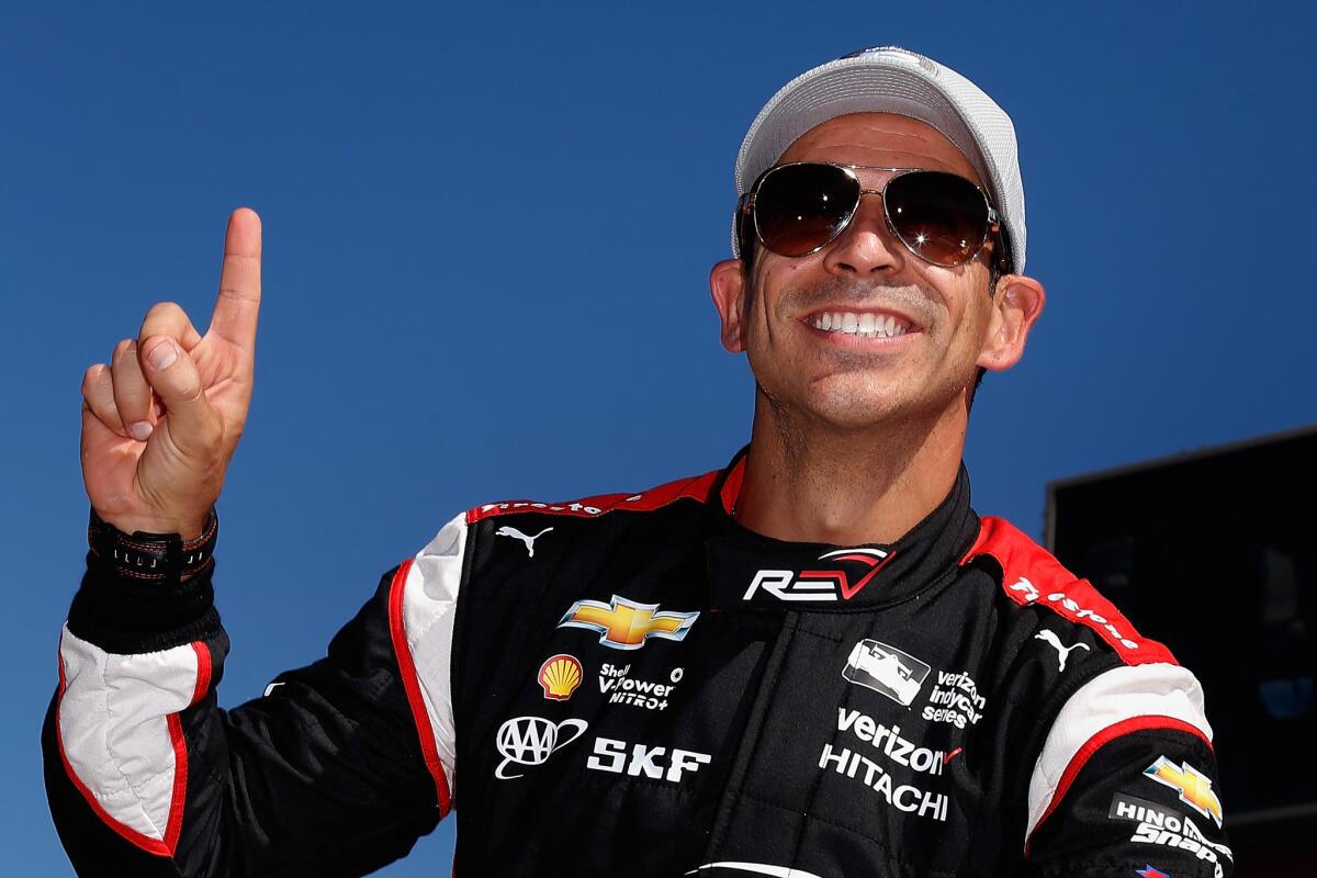 IndyCar driver Helio Castroneves celebrates Friday after winning the pole for the Phoenix Grand Prix.