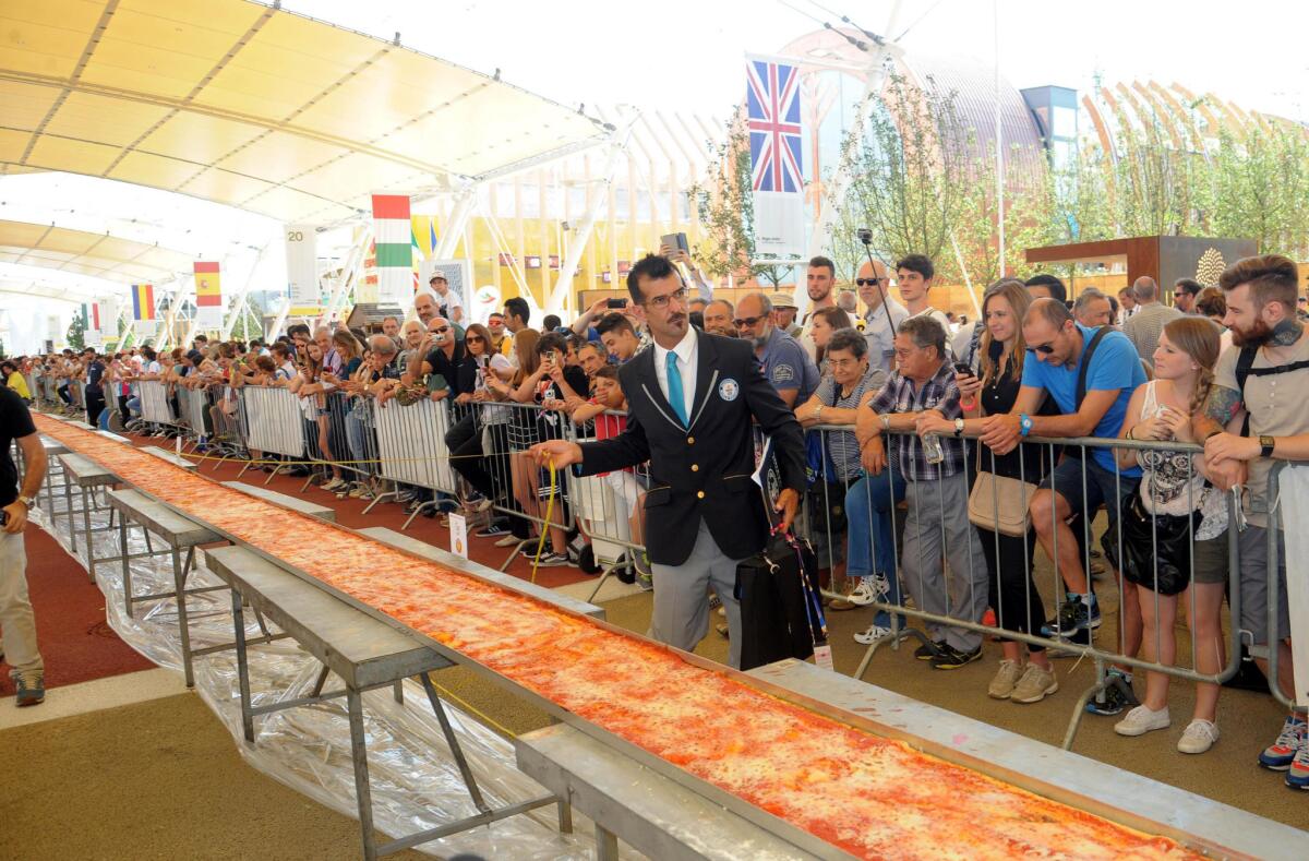 What's the world's record-setting pizza? Sixty pizza makers last month worked on this almost milelong pizza for Expo 2015 near Milan, Italy. Their work paid off: Guinness World Records confirmed it was the world's longest pizza (specifically 1.59545 kilometers).