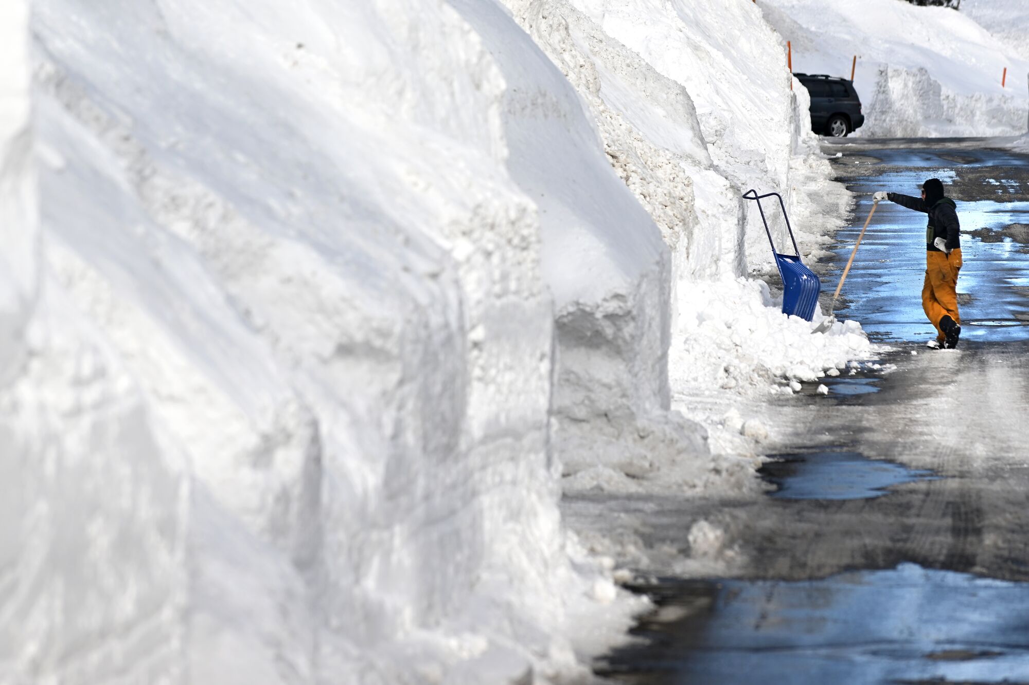 A Mammoth Lakes resident shovels snow on Davison Road.
