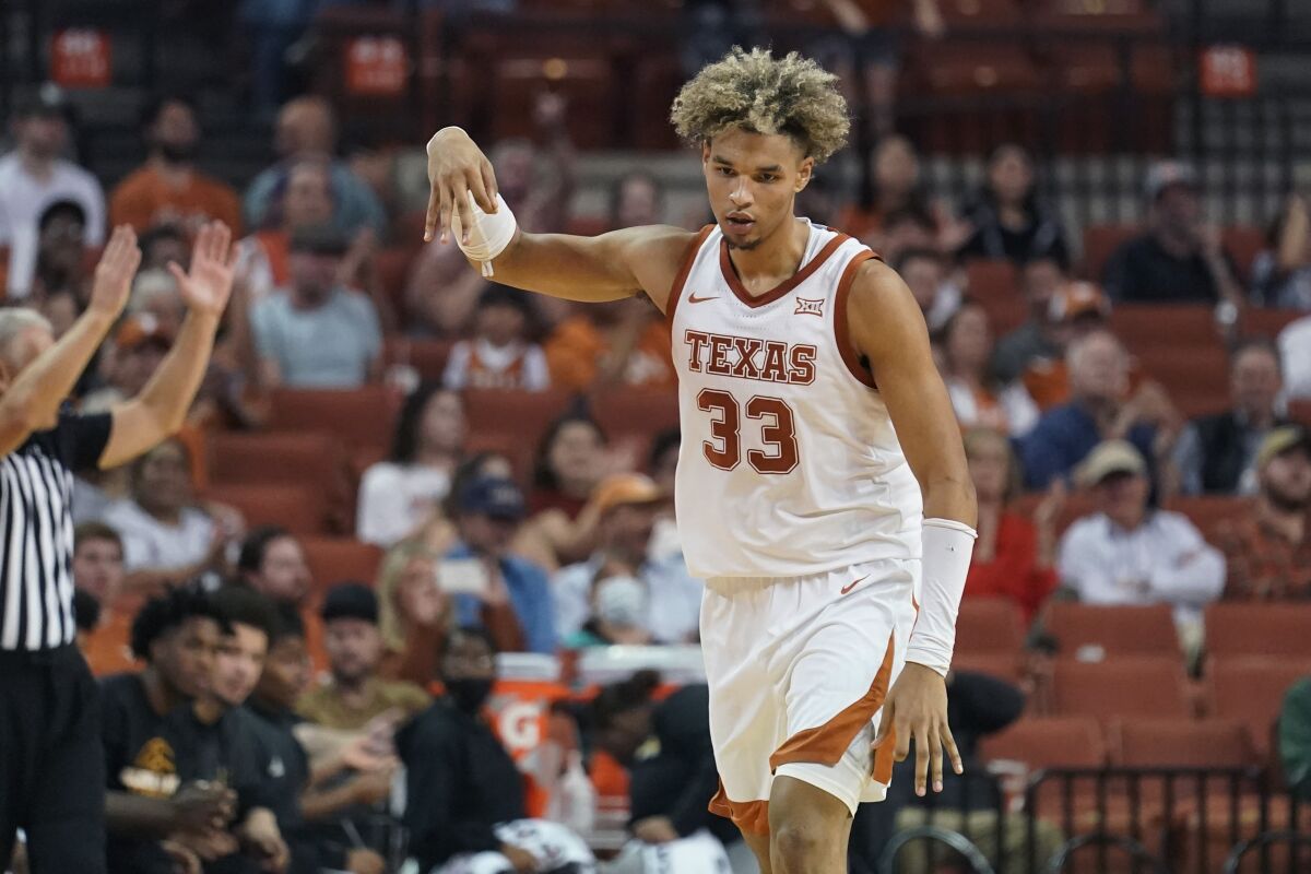Texas forward Tre Mitchell (33) reacts after scoring against Arkansas-Pine Bluff during the first half of an NCAA college basketball game, Tuesday, Dec. 14, 2021, in Austin, Texas. (AP Photo/Eric Gay)