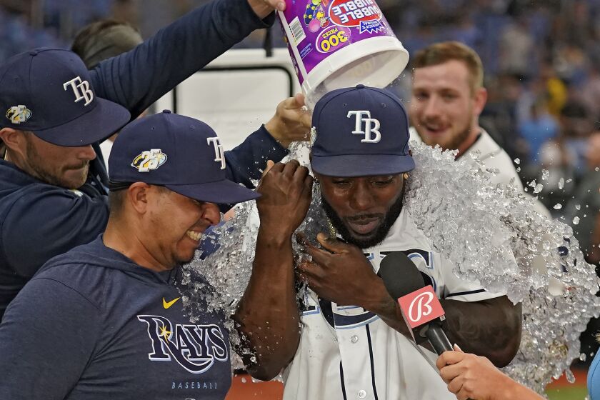 Tampa Bay Rays' Randy Arozarena, right, gets doused with ice water after his walk-off home run off Minnesota Twins relief pitcher Jhoan Duran during the ninth inning of a baseball game Wednesday, June 7, 2023, in St. Petersburg, Fla. (AP Photo/Chris O'Meara)