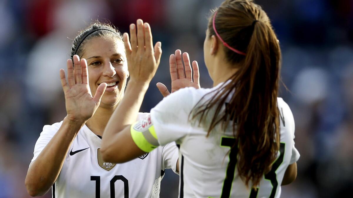 U.S. forward Carli Lloyd (10) celebrates a goal with teammate Alex Morgan during the first half of a 5-0 victory over Ireland.