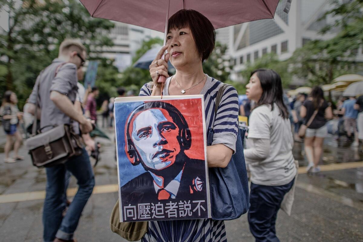 Aa woman holds a sign opposing U.S. surveillance techniques during a march in Hong Kong to support Edward Snowden.