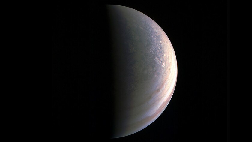 JunoCam obtained this view of Jupiter's north pole from a distance of 120,000 miles. The planet's north and south poles are mottled with rotating storms.