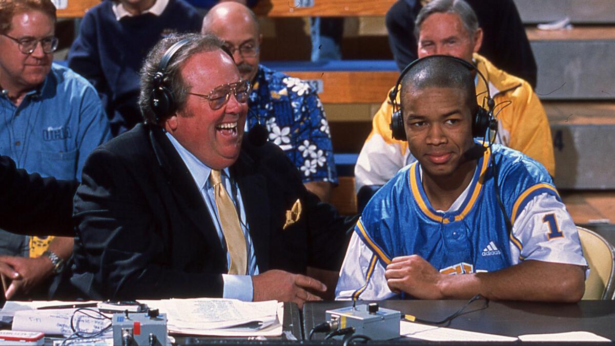 Chris Roberts, left, interviews UCLA basketball player Jason Flowers during a broadcast.