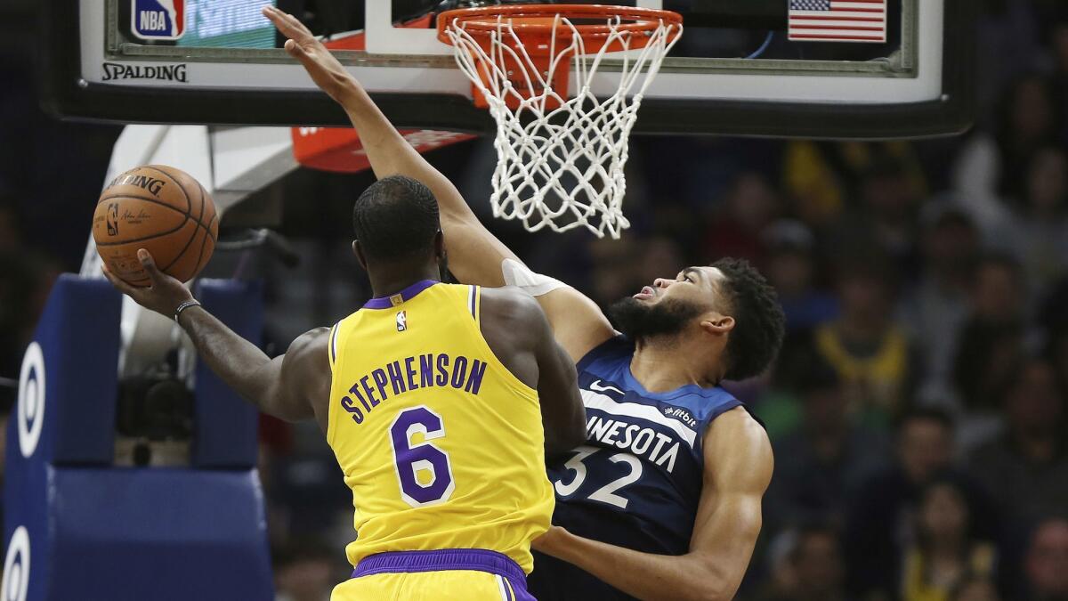 Lakers guard Lance Stephenson tries to score against Timberwolves center Karl-Anthony Towns during the first half Sunday.