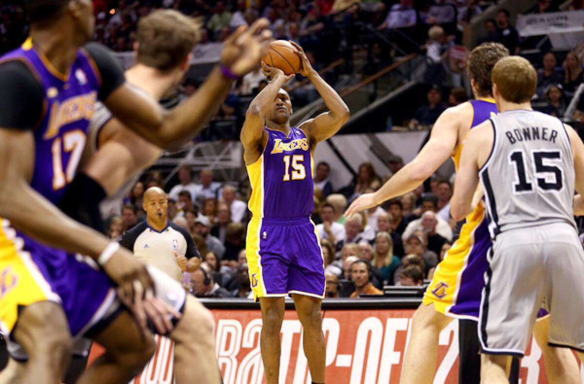 Lakers forward Metta World Peace lines up a wide-open shot as big men Dwight Howard, left, and Pau Gasol, right, are closely guarded in Game 1 of their playoff series against San Antonio.