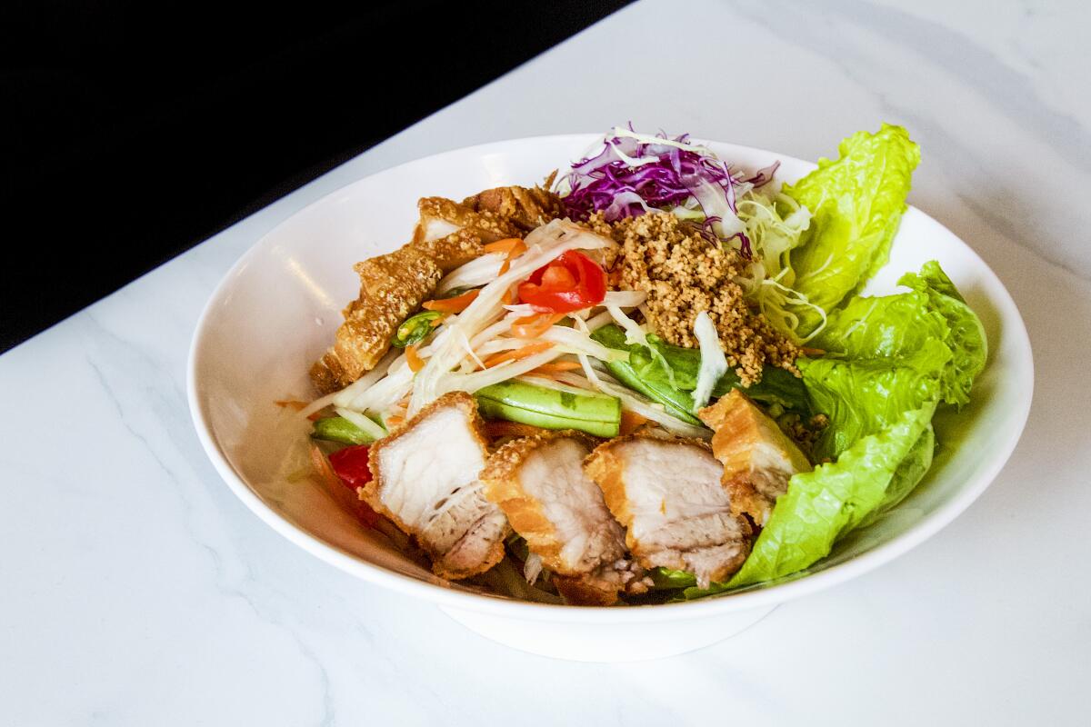 A photo of crispy pork with papaya salad from Mee Dee Thai Kitchen.