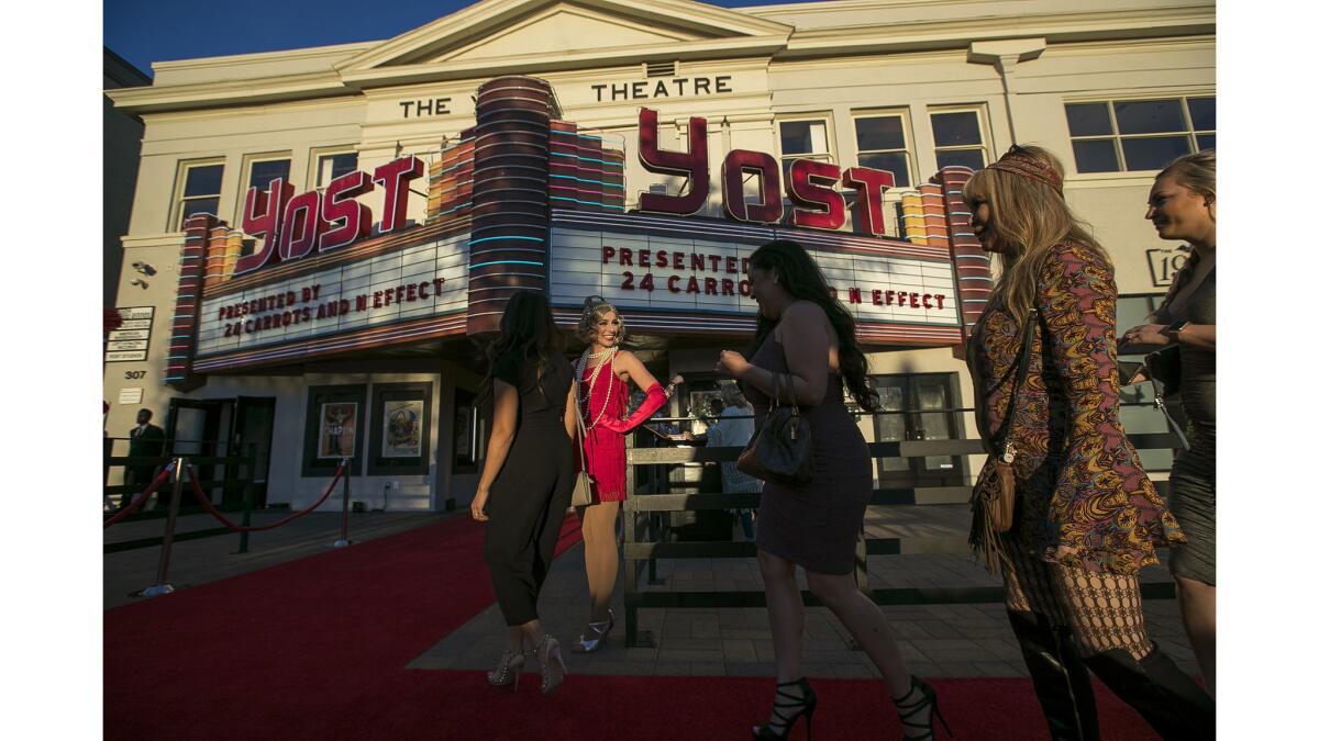 Taylor Jayne, center, welcomes guests to the grand reopening of the Yost Theater in Santa Ana on March 29.