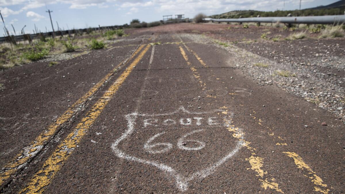 Hand-painted Route 66 'graffiti' on a neglected spur of a long rerouted Route 66 near Williams, Arizona. (Brian van der Brug / Los Angeles Times)