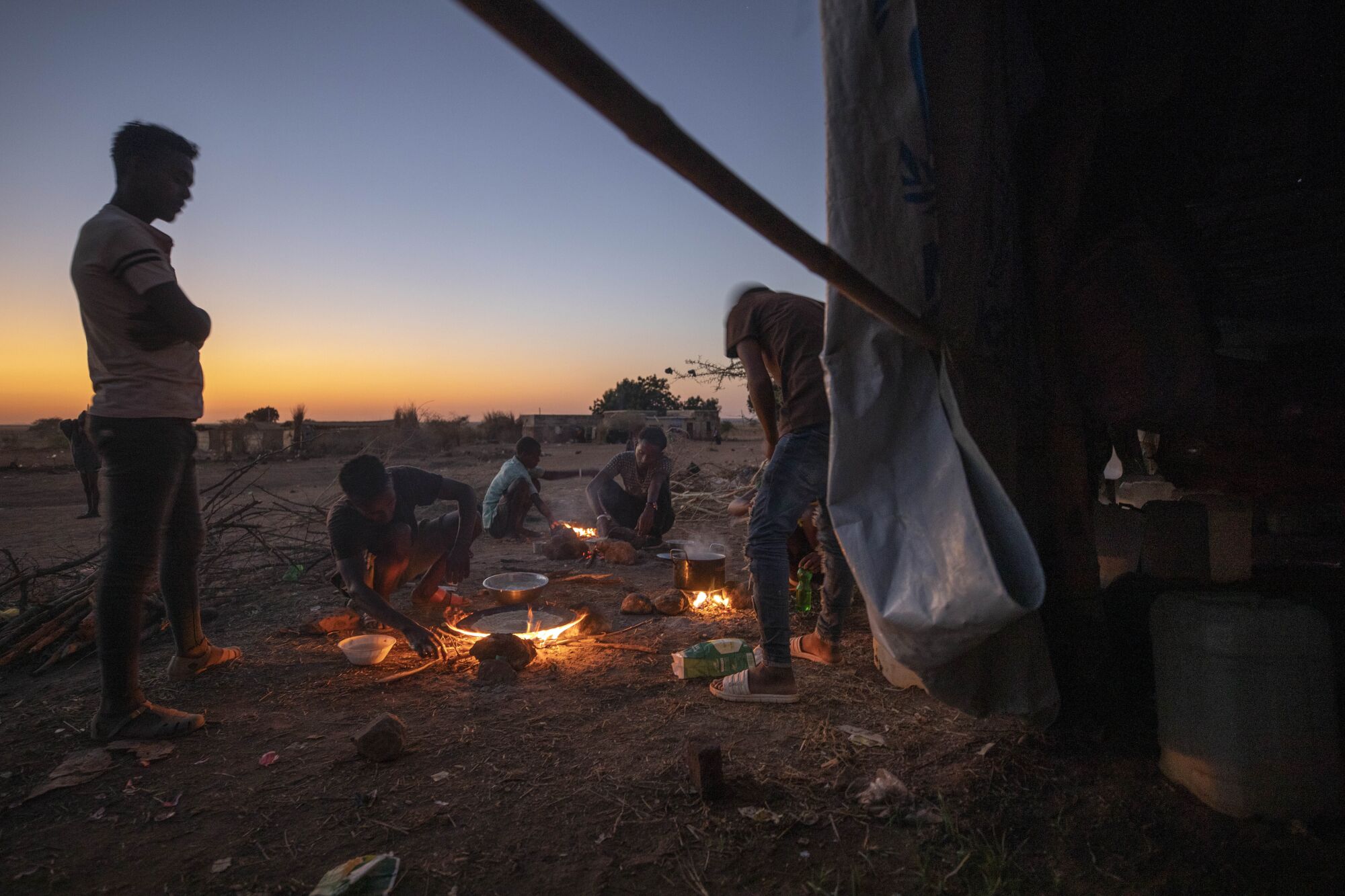 Tigray refugees light fires to prepare dinner at Umm Rakouba refugee camp Sudan