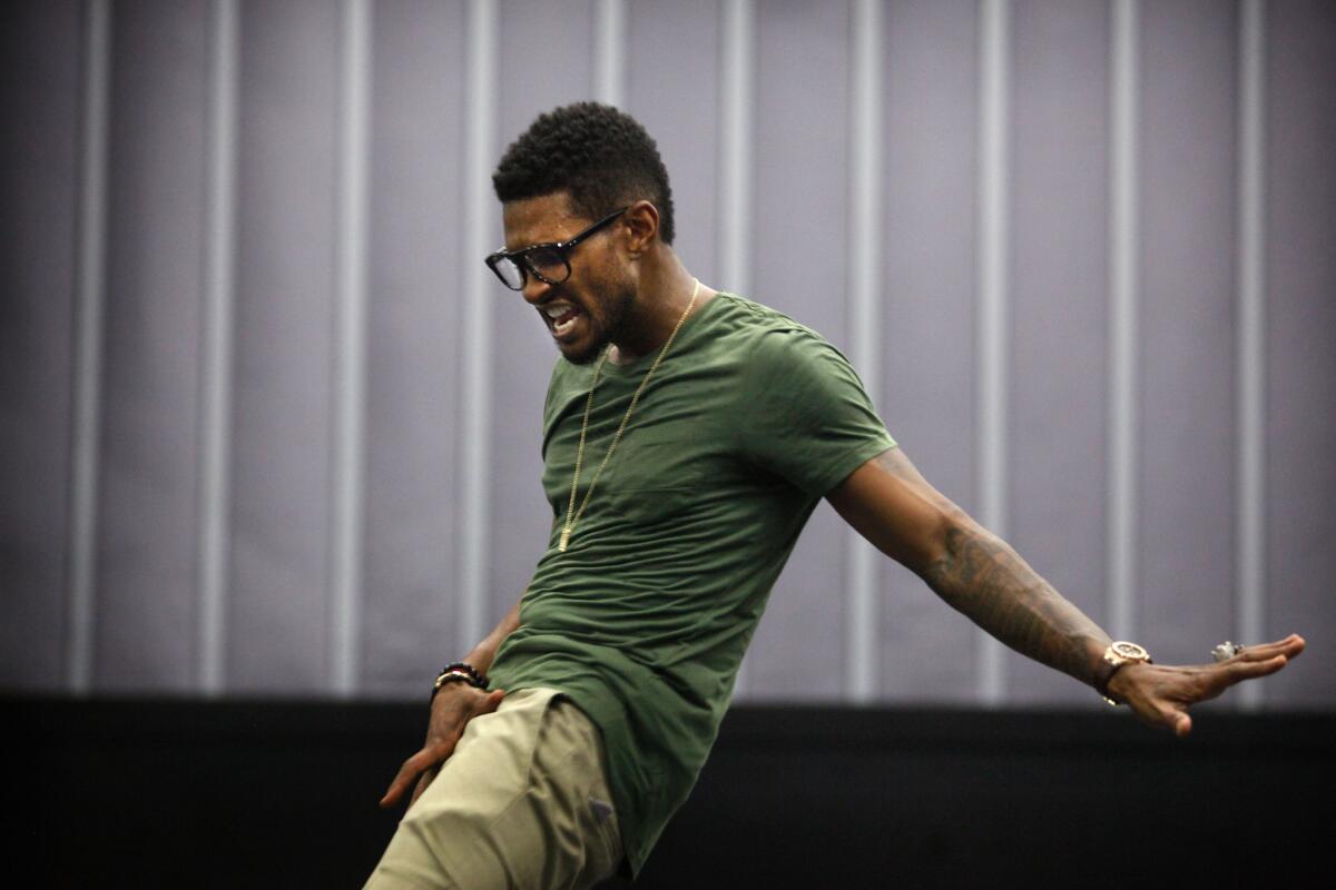 Usher is pictured here posing on his equipment crates and then working out with his dancers in Burbank, CA., June 02, 2012.