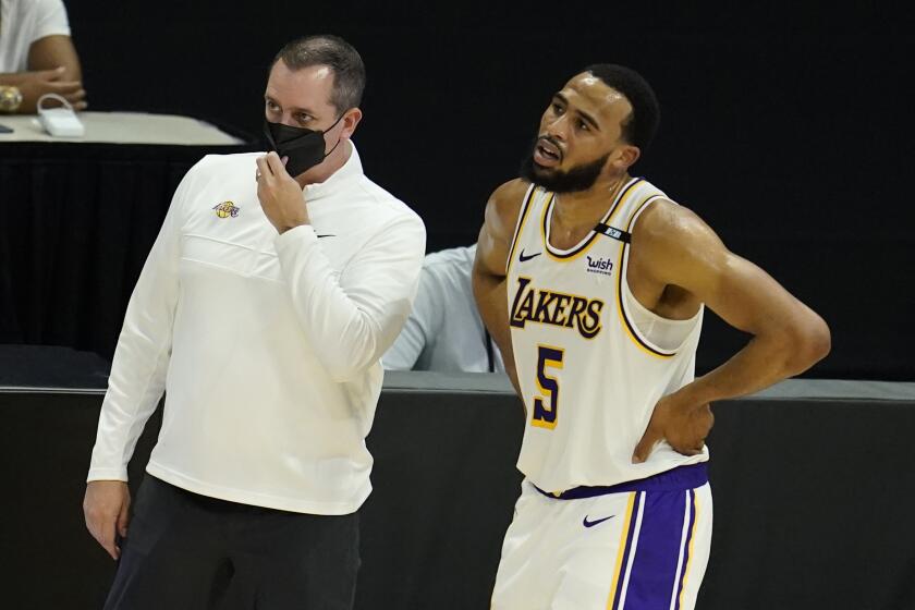Los Angeles Lakers head coach Frank Vogel , left, stands next to Los Angeles Lakers guard Talen Horton-Tucker.