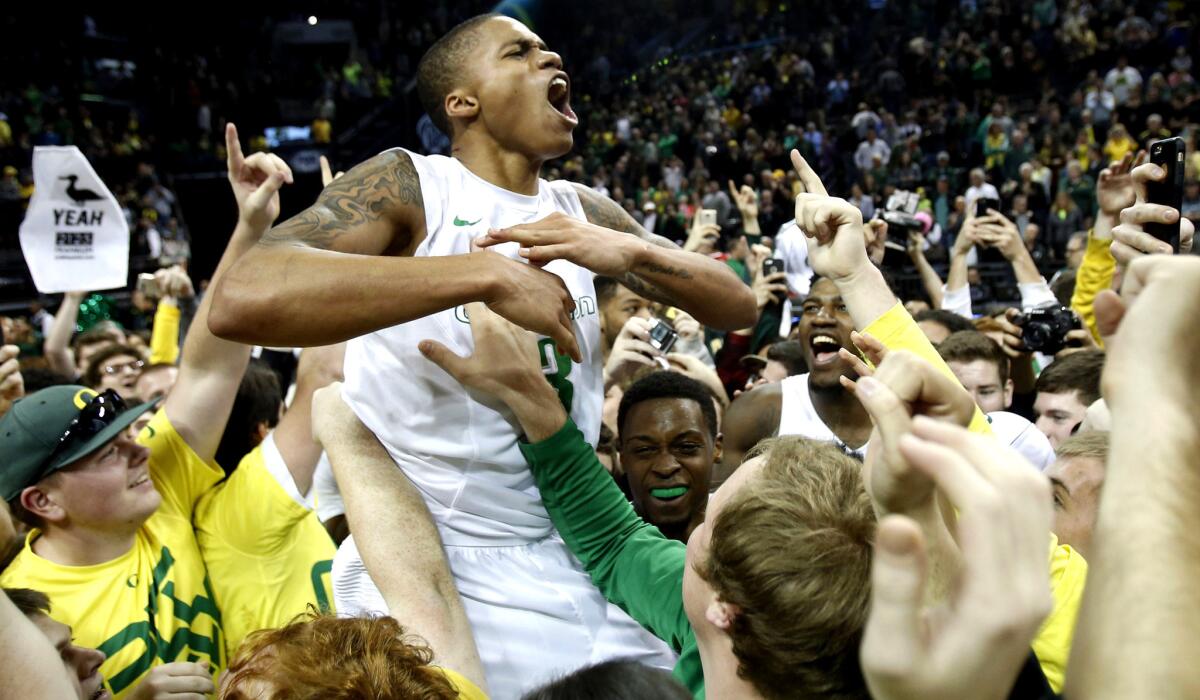 Oregon guard Joseph Young is hoisted by fans after the Ducks defeated No. 9 Utah on Sunday in Eugene, Ore.
