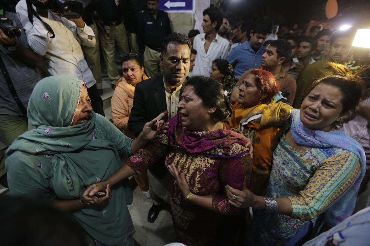 Relatives of the victims of the blast cry outside a hospital.