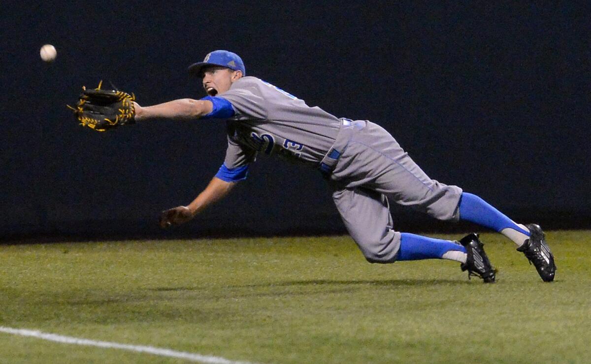Bruins outfielder Brett Stephens is unable to reach a triple hit by Maryland's Tim Lewis in the second inning Saturday at the UCLA Regional of the the NCAA college baseball tournament.