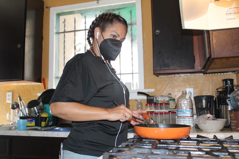 Karla Franco Hernández, a South Gate resident and mother of two LAUSD children, cooks at home