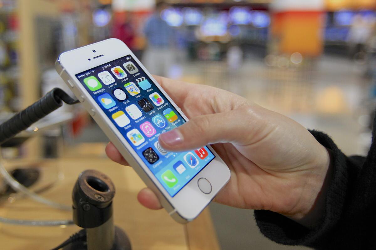 A customer examines a new iPhone 5s.
