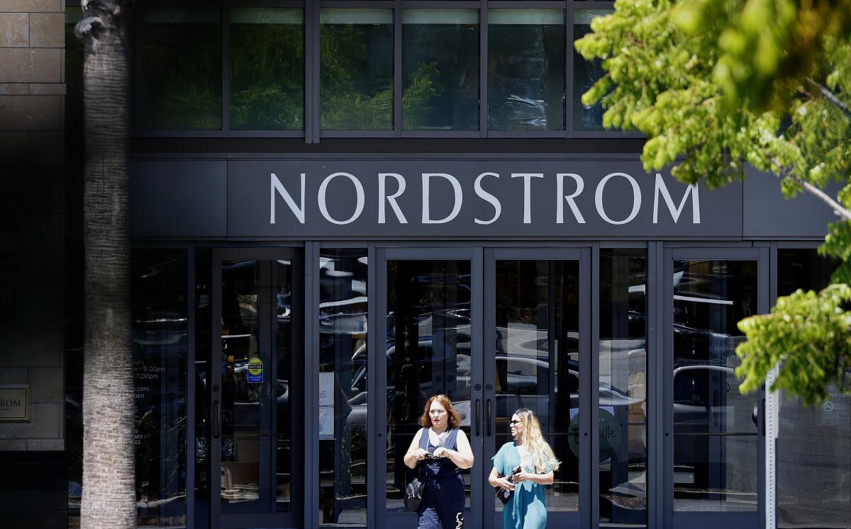 Two shoppers leave a Nordstrom.