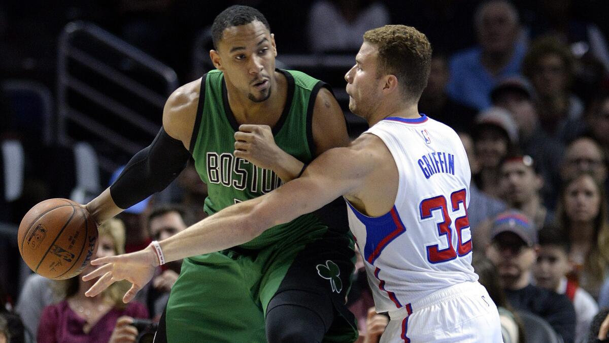 Clippers forward Blake Griffin, right, defends Celtics forward Jared Sullinger during Monday's game at Staples Center.