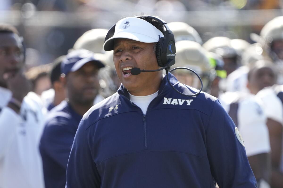 Navy head coach Ken Niumatalolo yells to an official during the first half of an NCAA college football.