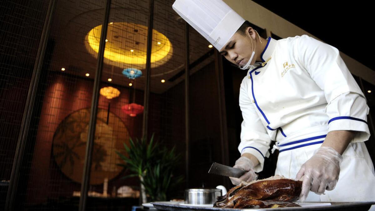 Chef Ted Yang carves the Meizhou duck at Dongpo restaurant.