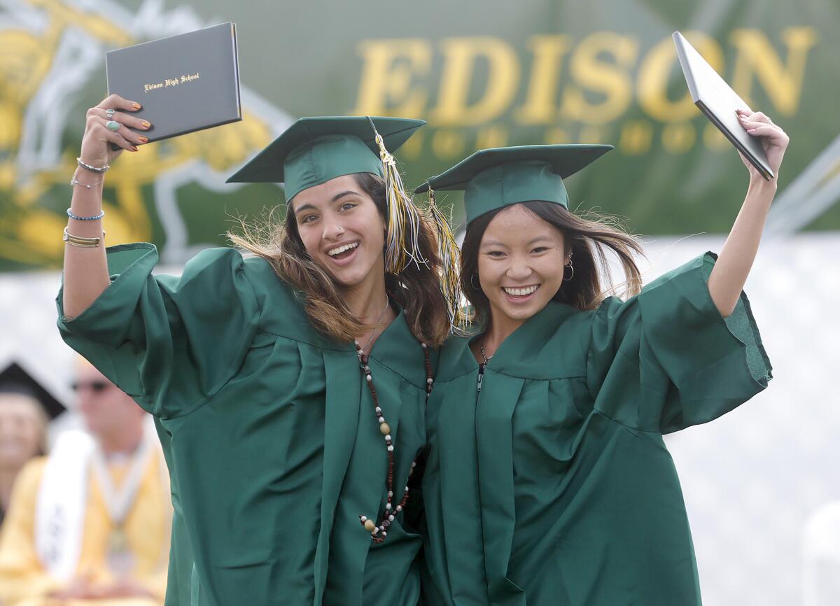 Elated graduates Aurora Garza and Krystal Dang at the 2022 Edison High graduation ceremony on Thursday.