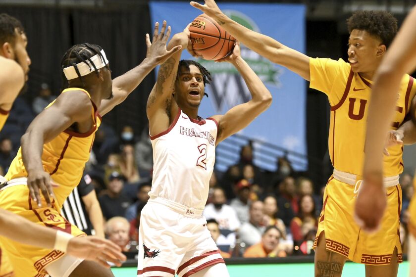 Southern California forward Chevez Goodwin, left, and guard Boogie Ellis defend against Saint Joseph's guard Erik Reynolds II in the second half an NCAA college basketball game at the Wooden Legacy tournament in Anaheim, Calif., Thursday, Nov. 25, 2021. (AP Photo/Jayne Kamin-Oncea)