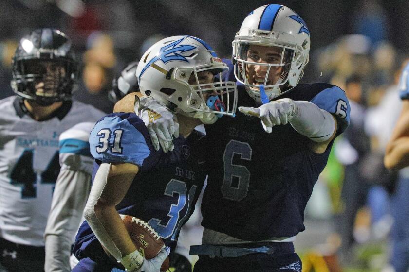 Corona del Mar's Riley Binnquist and teammate John Humphrey celebrate a touchdown he just scored against Santiago sin a CIF first round division III playoff football game at Newport Harbor High School on Friday, November 8, 2019. CDM lead Santiago 35-0 at halftime.