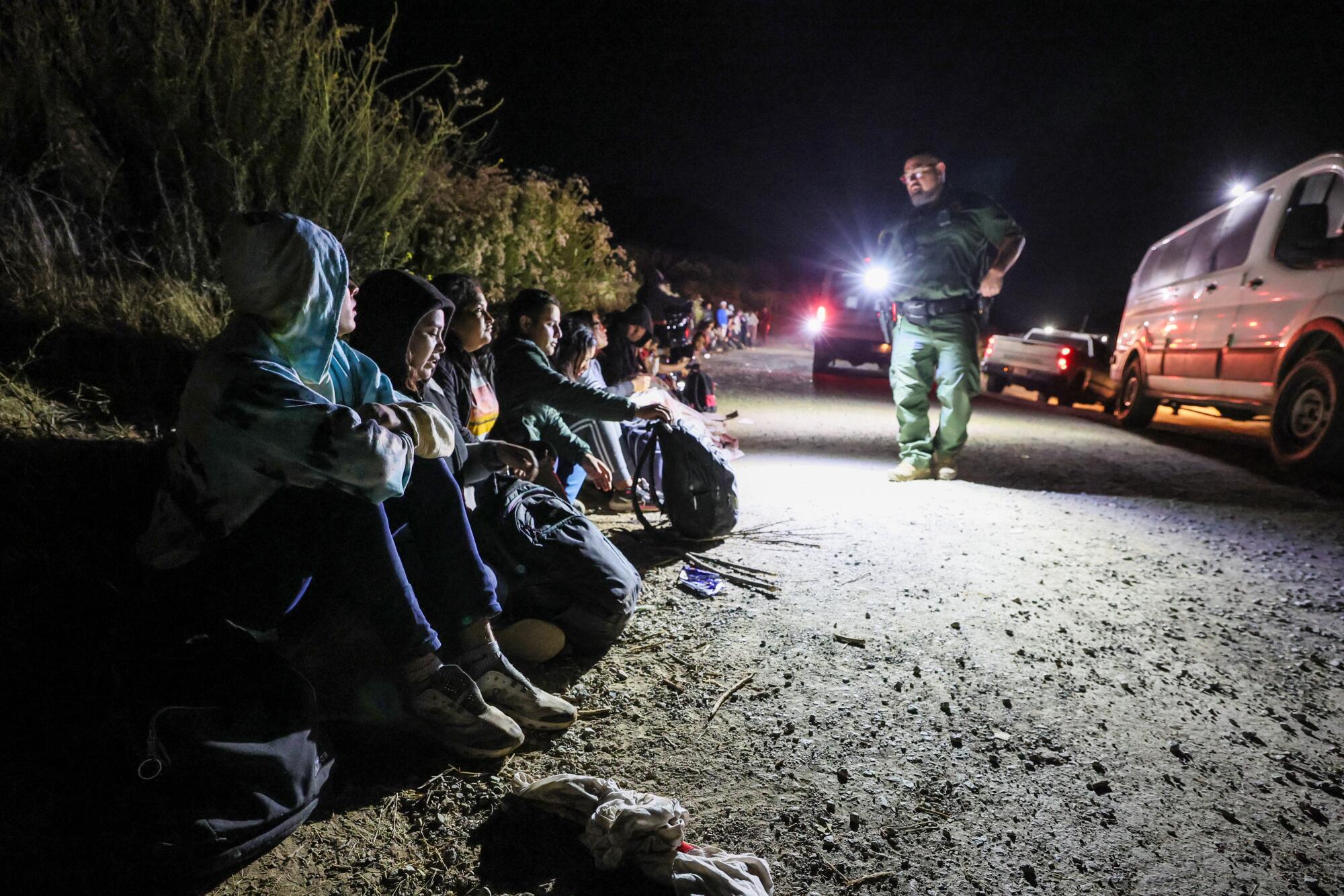 Asylum seekers wait to board border patrol vehicles near Campo Road after hiking 9 plus hours over Mt. Cuchoma.