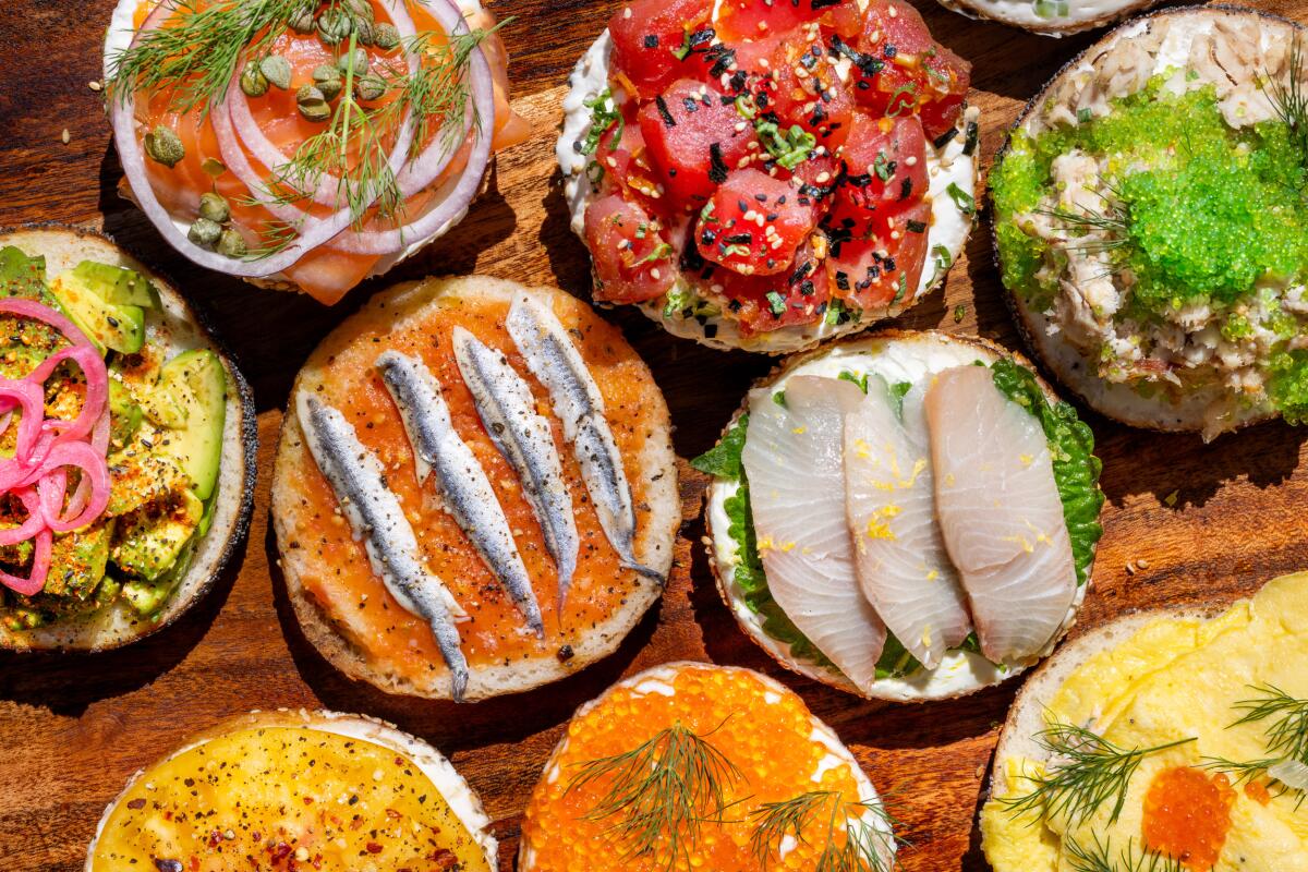 A selection of bagel halves from Smögen Appetizers topped with ahi poke, sardines, hamachi and more.