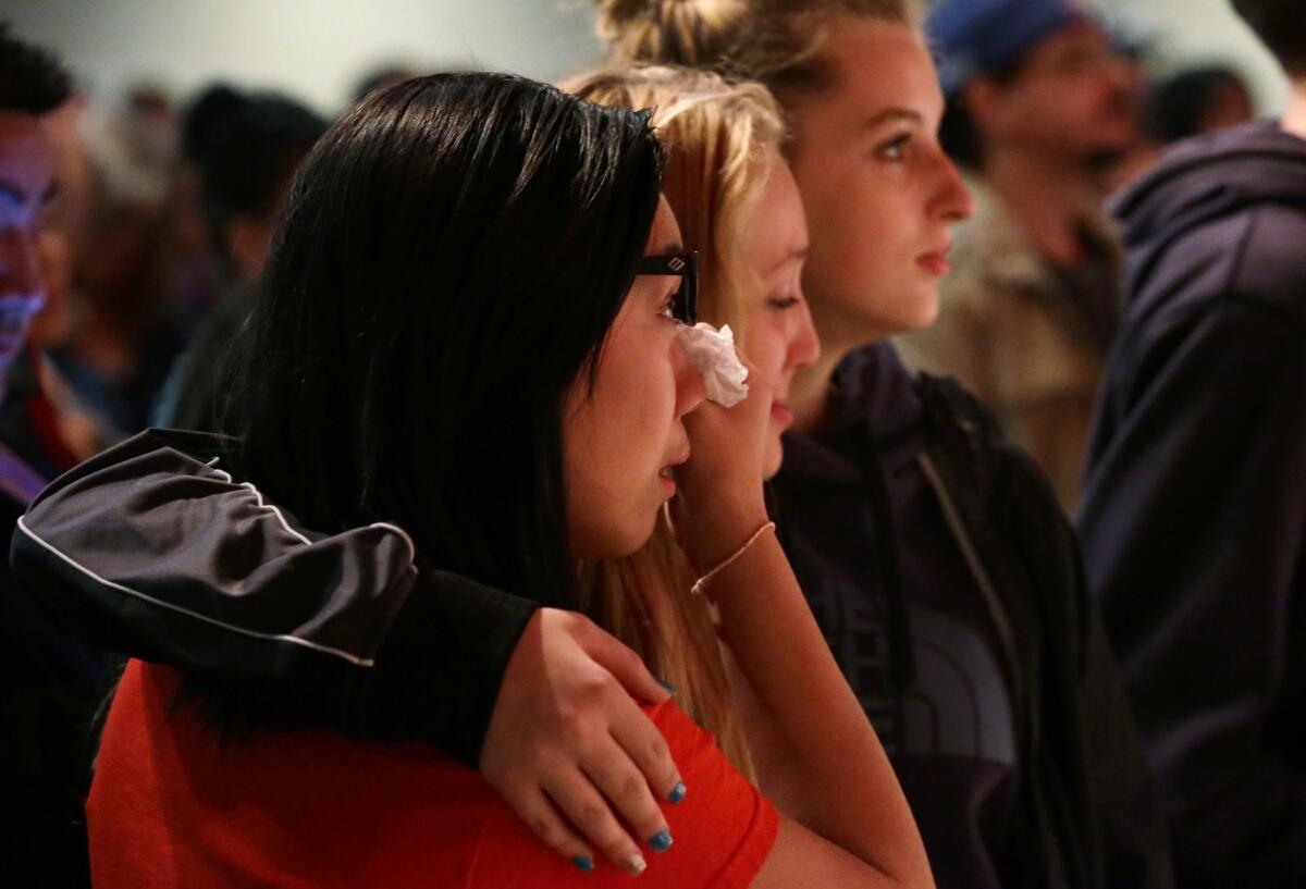 Mourners attend a vigil at the Grove Church in Marysville, Wash., Friday night for victims of the shooting at Marysville-Pilchuck High School.