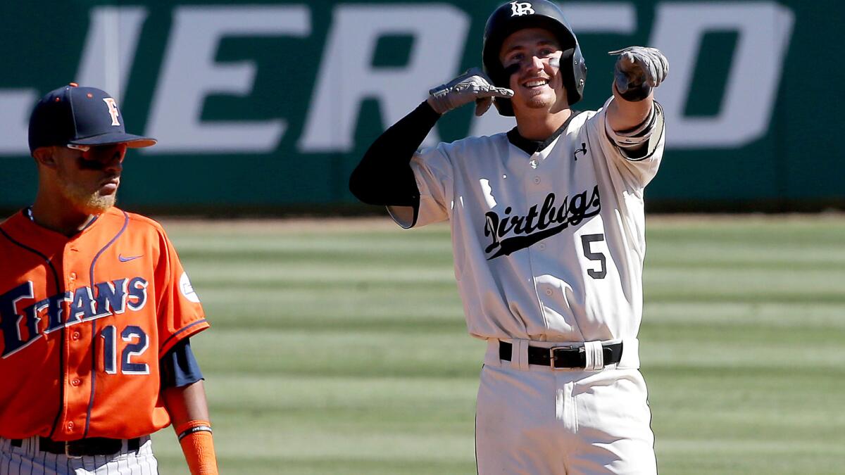 Long Beach State shortstop Laine Huffman (5) celebrates after doubling against Fullerton in the fourth inning Friday.