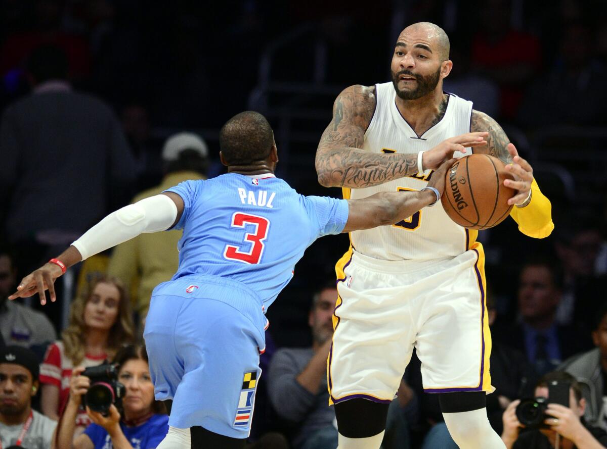 Clippers point guard Chris Paul tries to steal the ball from Lakers forward Carlos Boozer in the second half.