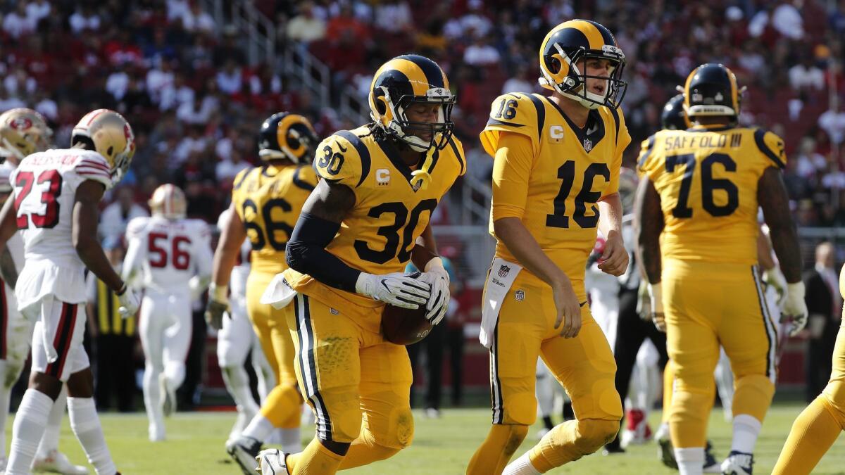 Rams running back Todd Gurley (30) leaves the end zone with quarterback Jared Goff (16) after scoring against the 49ers.