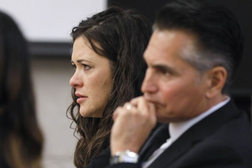 Vista, CA - December 07: Jade Janks listens to the opening statement of prosecutor Jorge Del Portillo on the first day of her murder trial at the Vista Courthouse. With her is lawyer Marc Carlos. (Charlie Neuman / For The San Diego Union-Tribune)