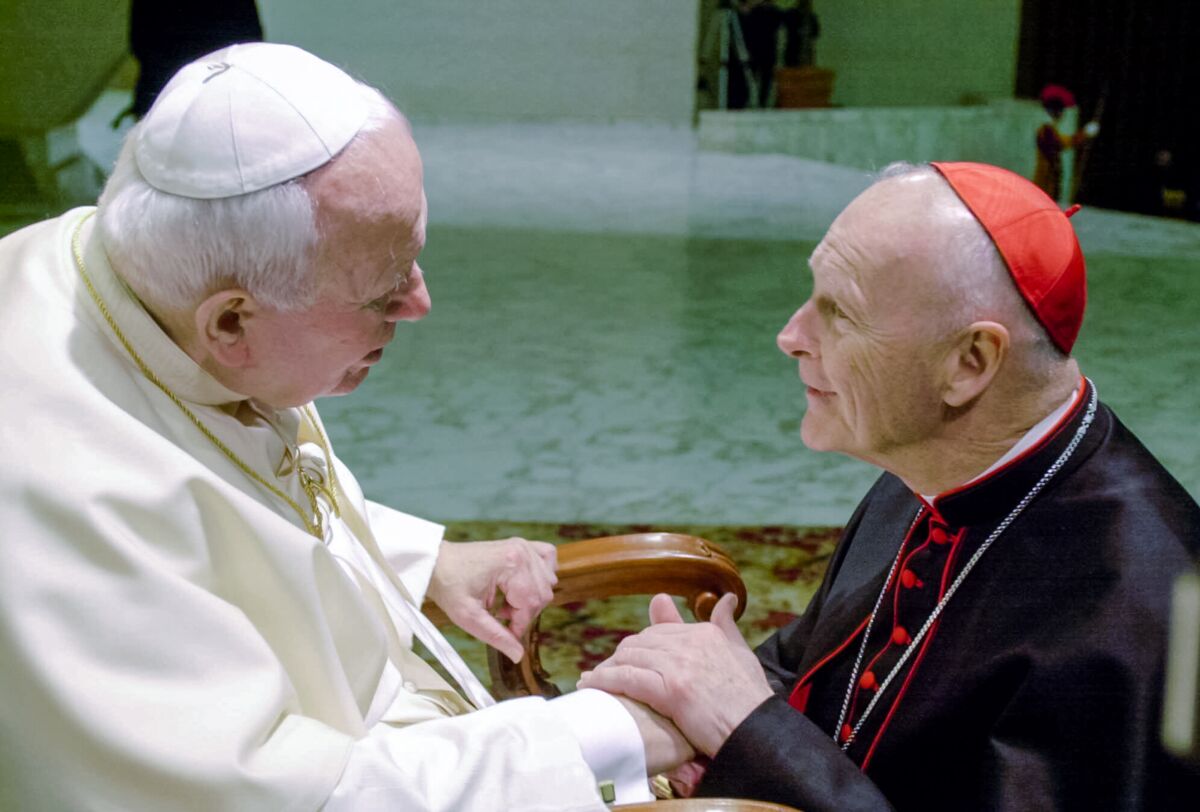 Pope John Paul II shakes hands with Cardinal Theodore McCarrick, archbishop of Washington, in 2001.