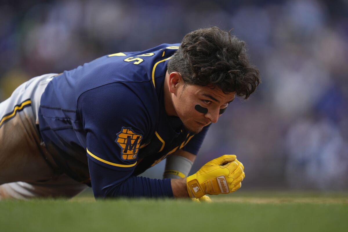 Milwaukee Brewers second baseman Luis Urias gets up after being tagged out at first during the ninth inning of a baseball game against the Chicago Cubs Thursday, March 30, 2023, in Chicago. The Cubs won 4-0. (AP Photo/Erin Hooley)