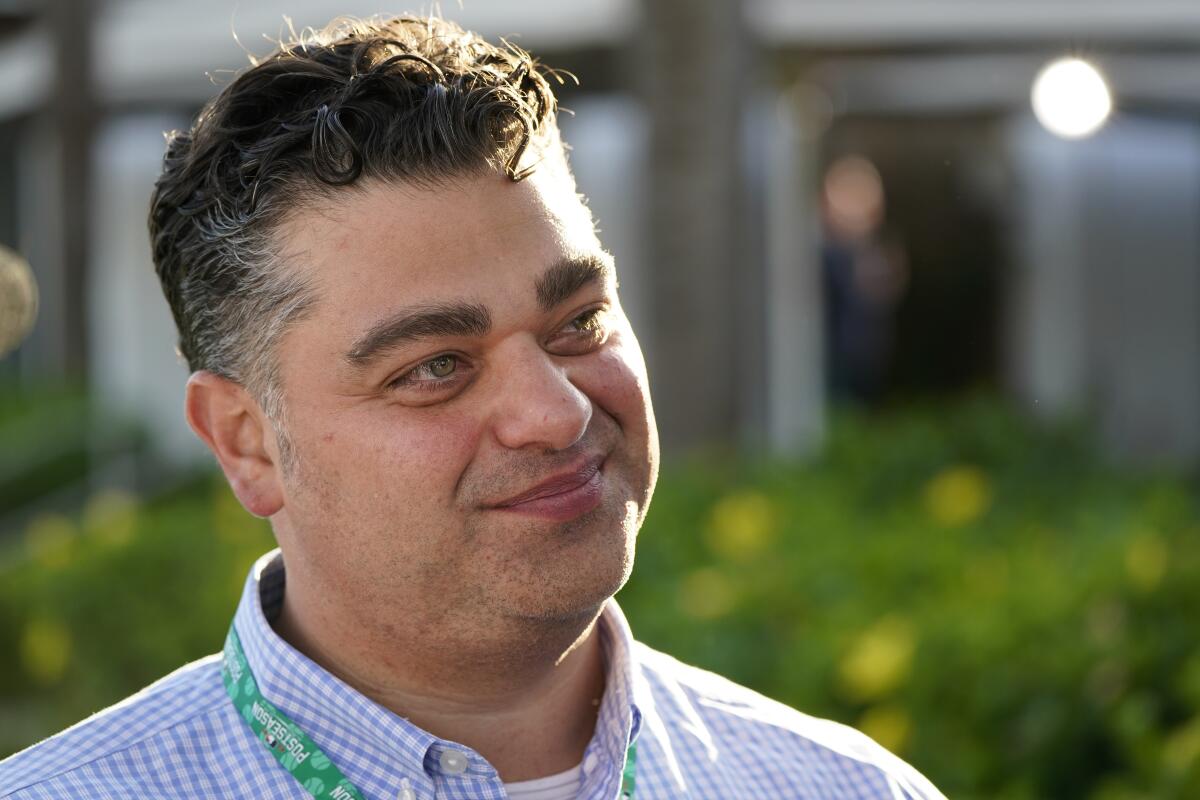 Angels general manager Perry Minasian talks with reporters during MLB's general managers meetings.