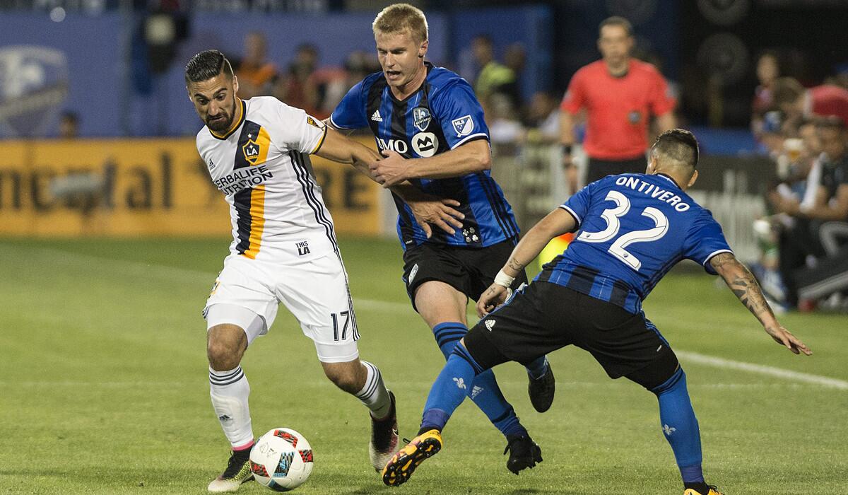 Montreal Impact's Kyle Fisher, center, and Lucas Ontiver, right, challenge Galaxy's Sebastian Lletget during second half on May 28.