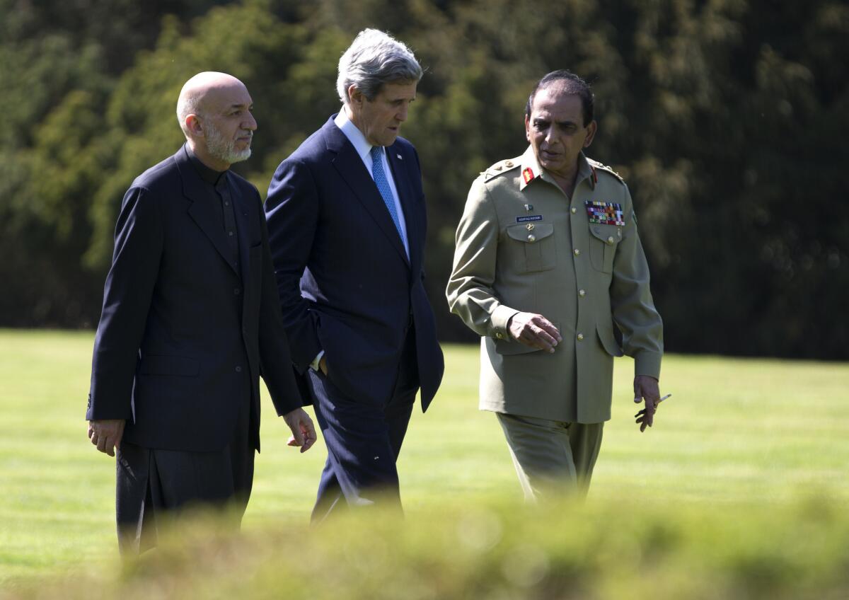 U.S. Secretary of State John F. Kerry, center, talks with Afghan President Hamid Karzai, left, and Pakistani army chief Gen. Ashfaq Kayani during a break in a meeting in Brussels.