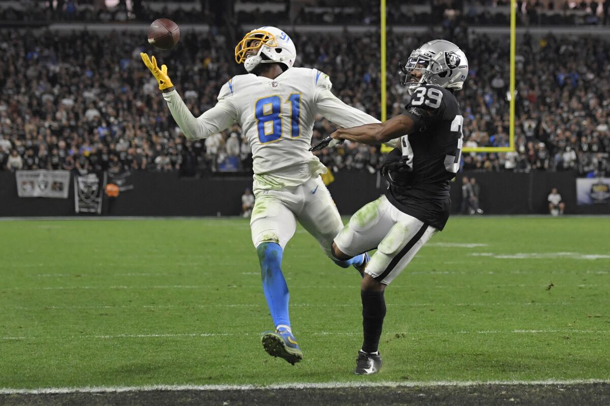 Chargers wide receiver Mike Williams (81) misses a reception attempt ass Raiders cornerback Nate Hobbs covers.