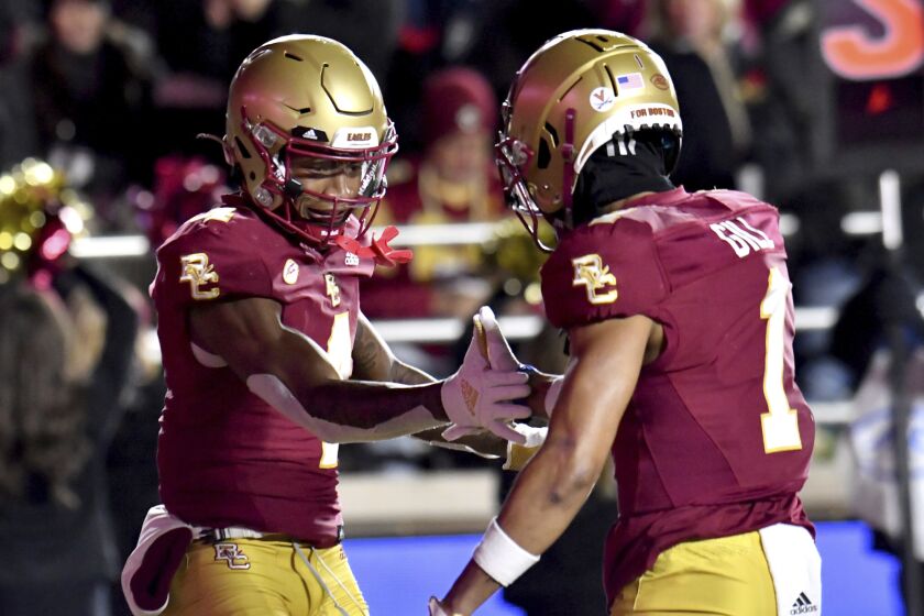 Boston College Zay Flowers (4) and Jaelen Gill (1) celbrate Flowers' touchdown during the first half of an NCAA college football game against Syracuse, Saturday, Nov. 26, 2022, in Boston. (AP Photo/Mark Stockwell)