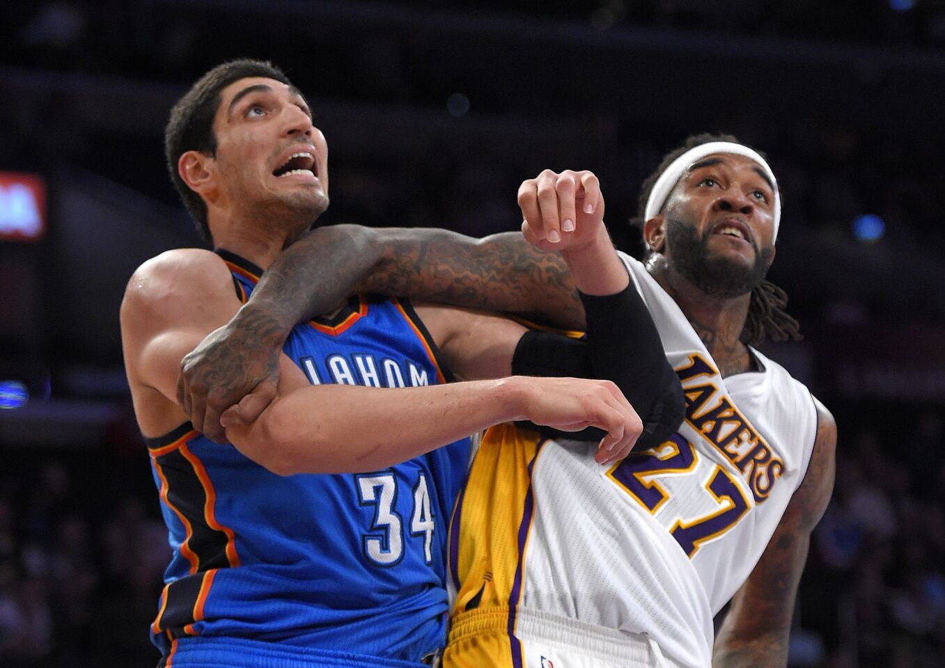 Thunder center Enes Kanter and Lakers center Jordan Hill battle for position under the basket.