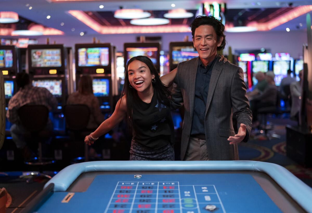 A young woman and a man in a casino.