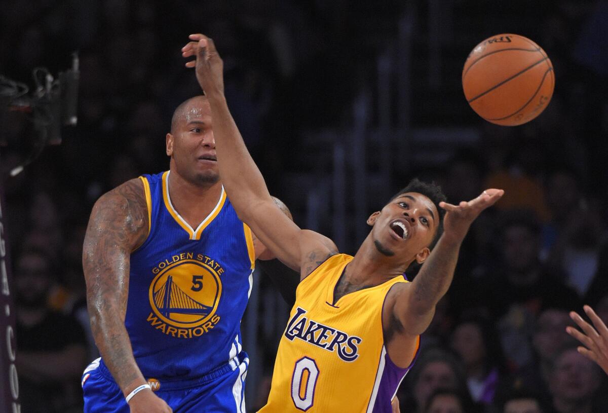 Lakers forward Nick Young can't grab the basketball as Warriors forward Marreese Speights looks on during a game this season.